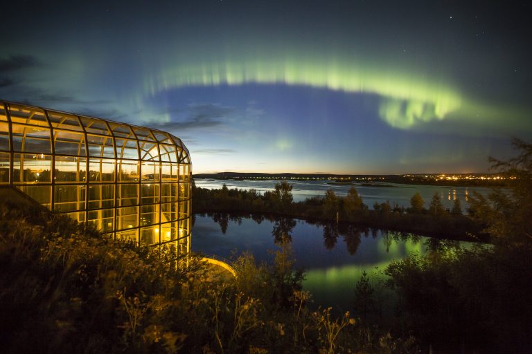 View of Arktikum and northern lights in Rovaniemi, Lapland