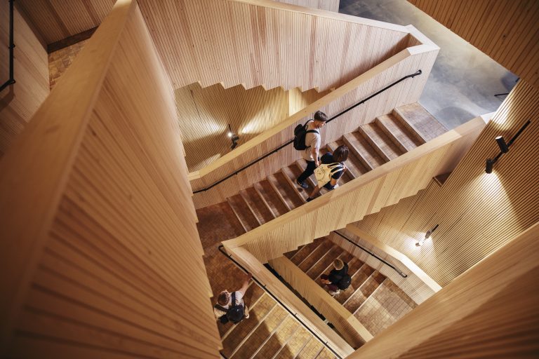 View of a staircase from above and people walking downstairs