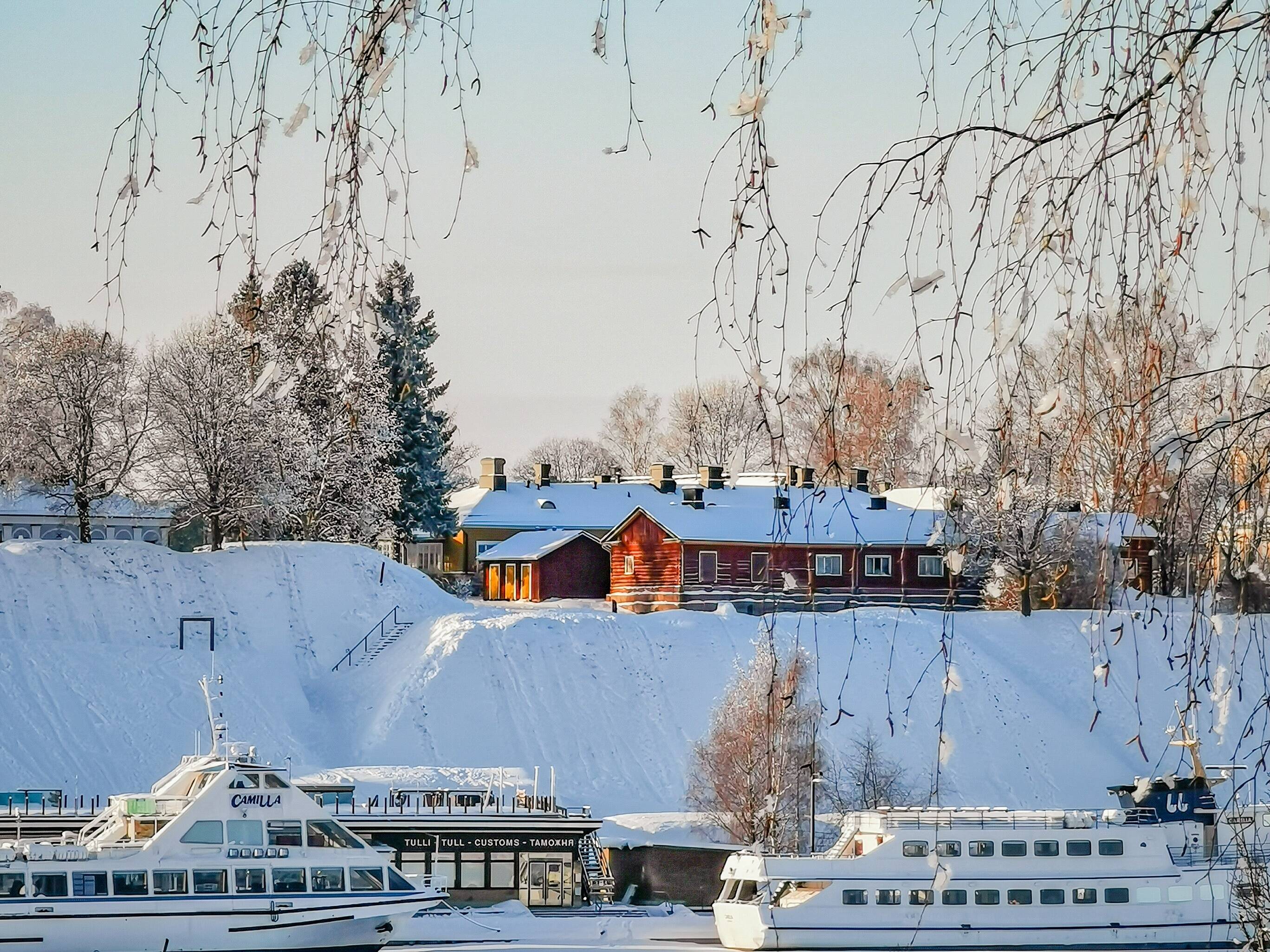 Ships and boats on a pier in snow-covered city of Lappeenranta.