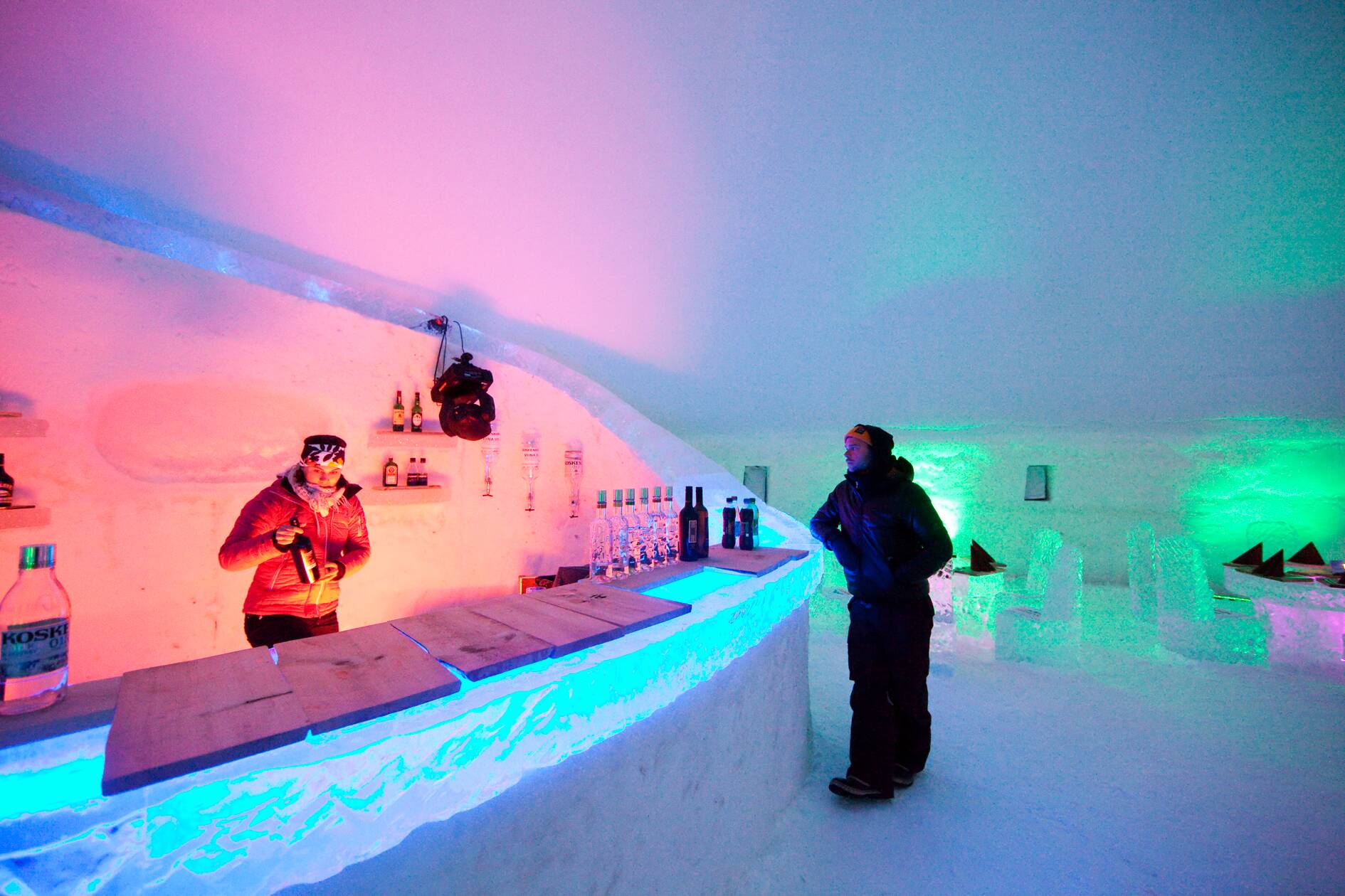 A bar made out of ice and lit with colourful lights