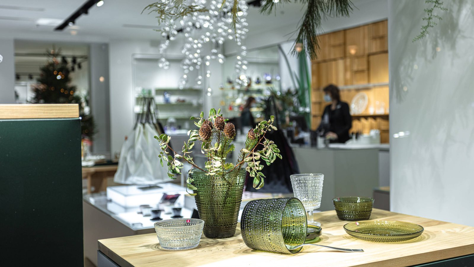 Inside of an Iittala store with vases, plates and flowers displayed