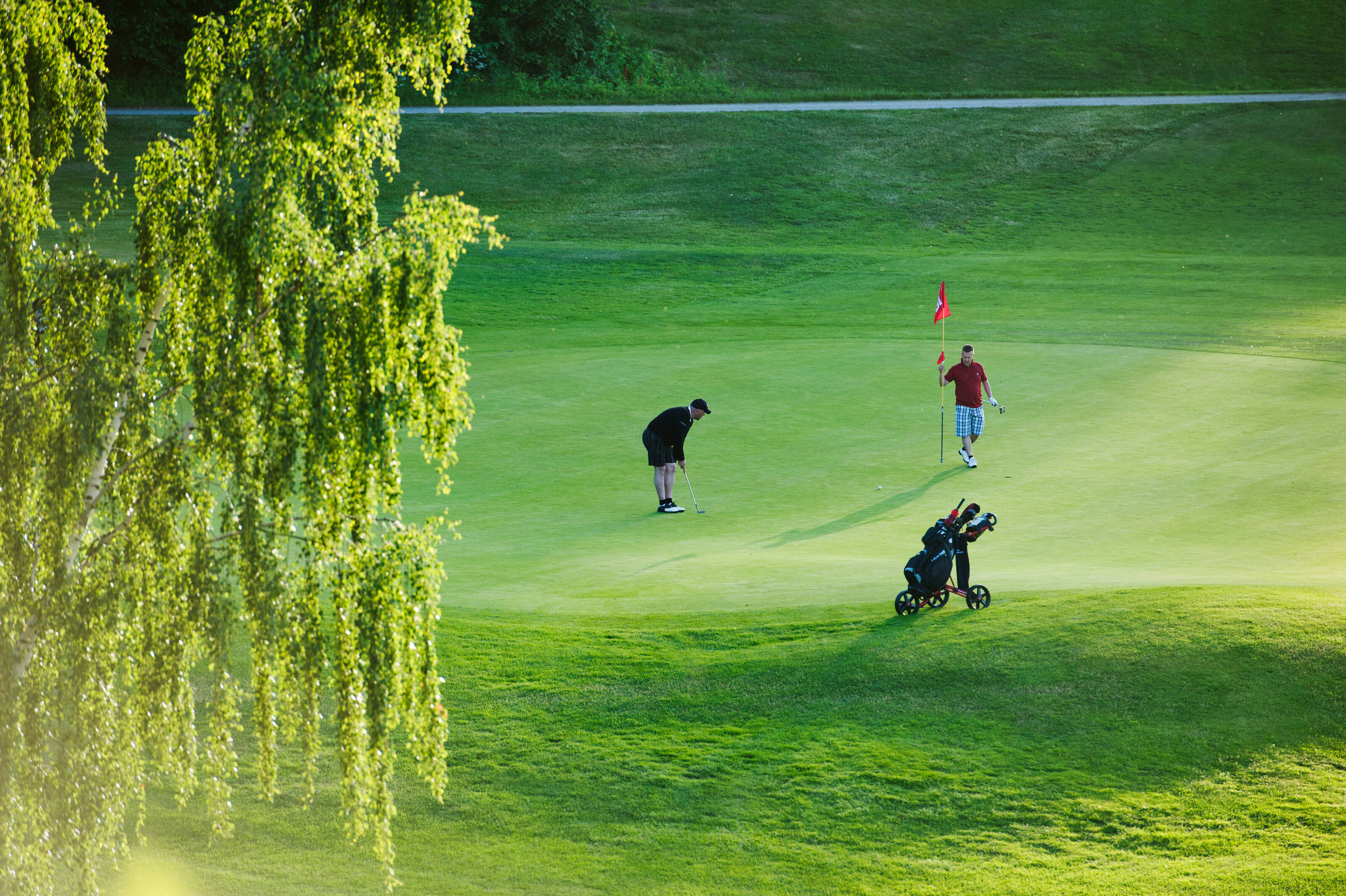 A golfer hits the ball on a golf course in Finland.