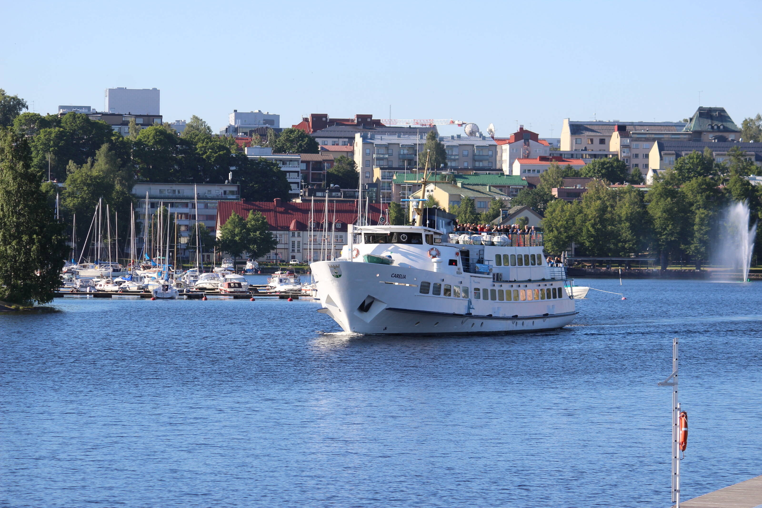 A small cruise ship sailing in the Lake Saimaa in the front of city of Lappeenranta.