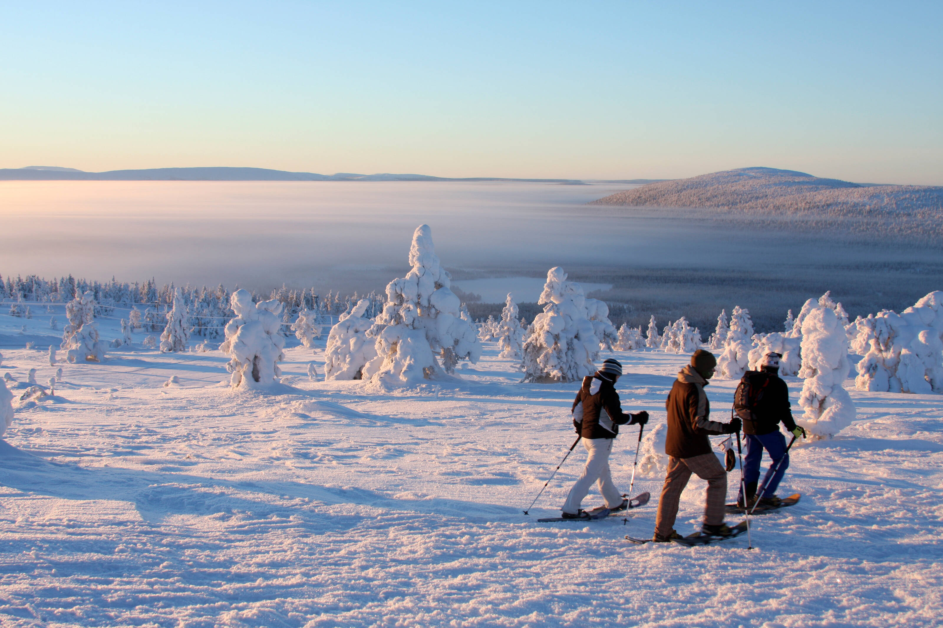 Three people snowshoeing in Lapland